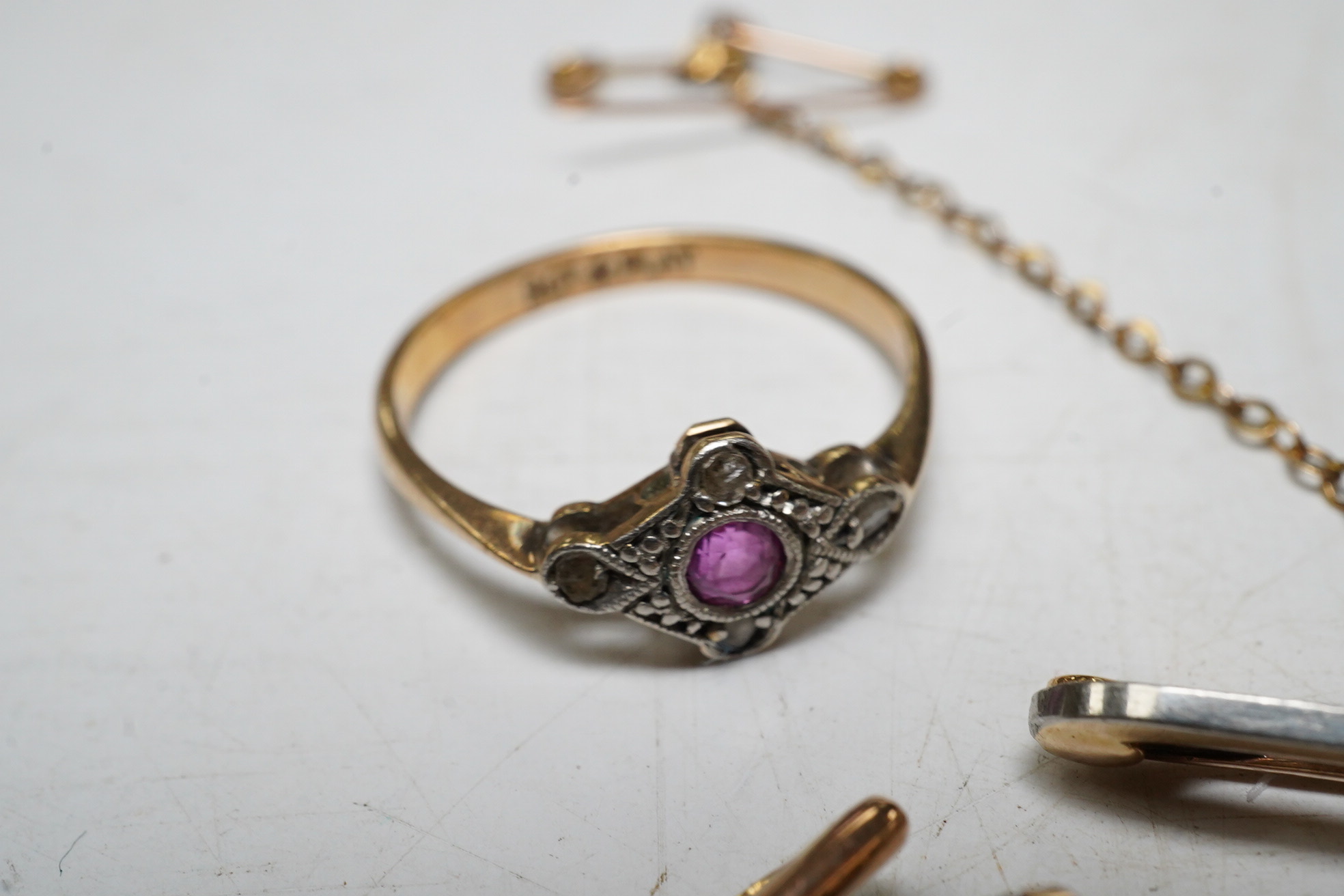 An enamelled 15ct gold Royal Engineer's sweethearts brooch with diamond chips, 5cm, gross 5.8 grams, a gold wrist watch, a 9ct gold and amethyst bar brooch, 2.1 grams, a ruby and diamond chip set 9ct gold dress ring, gro